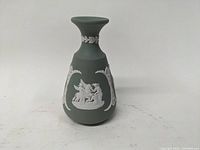 Green Wedgwood Jasper Ware vase front showing cherubs scene decoration