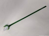 Full view of the Murano glass flower showing green stem and white closed flower at the end