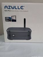 Front view of sealed Azulle Byte Plus mini PC retail box showing product image, Intel Atom and Windows logos.