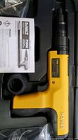 Yellow and black DeWALT P3500 powder actuated tool with visible model number on side, inside plastic molded case.