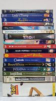 All 17 Disney DVD titles stacked with clear visible spines showing titles and editions