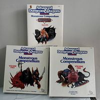 Three Advanced Dungeons & Dragons 2nd Edition Monstrous Compendiums side by side; Volume One and Volume Two with fantasy monster art, and Ravenloft Appendix with werewolf and shadowy figure on the cover.