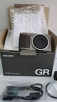 Camera and bubble-wrapped manuals in original Ricoh GR box