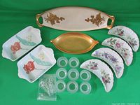 Full view of all trays, glass salt bowls, and spoons on green background