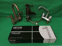 Four faucets with one new Jacuzzi Callum faucet in original box and three other faucets in good used condition.