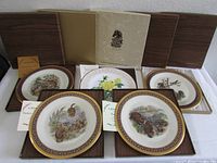 Set of 5 Lenox Boehm limited issue collectible plates with original boxes and certificates visible, featuring detailed animal and floral illustrations.