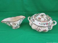 Photo of Coalport Indian Tree covered dish and gravy boat set showing overall shape and detailing against green background.