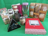 Photo showing large Pink Floyd tin, Jim Beam tin, fog-free mirror in packaging, and assorted cylindrical containers