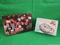 Boxed E.L.F. 20-piece nail polish set and Spa Essentials manicure and pedicure kit with nail dryer.
