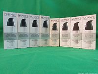 Front display of the 8 boxed items arranged side by side against green background; 4 boxes each for Serum Concentrate and Eye Cream.