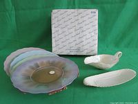 4 Princess House glass plates with pastel edges, Lenox gravy boat and butter dish on green backdrop