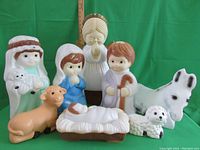 Full set of 8 vintage blow mold nativity figures against green background with measuring stick showing size about 18 inches tall.