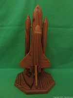 Front view of the wooden NASA Space Shuttle model showing orbiter, boosters, and base.