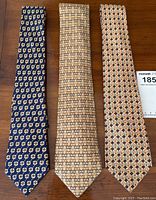 Three ties laid flat on wood surface showing all patterns