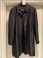 Full front view of coat hanging on a door