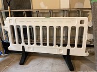 Front view of one assembled barrier panel with two black feet.