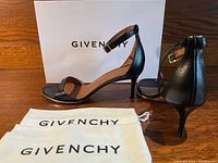 Side view of both shoes with box and dust bags