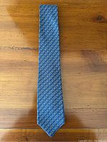 Full view of tie laid flat on wooden surface