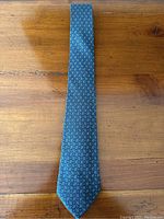 Full view of tie blade front on wood surface