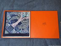 Scarf folded inside open Hermès orange box