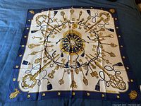 Full view of scarf laid flat showing overall keys design and hand-rolled edges