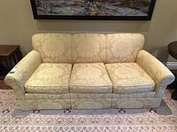 Front view of sofa showing overall style, upholstery pattern and three cushions