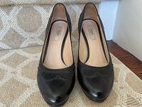 Pair of Prada pumps front view showing toe shape and stitched detail