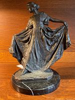 Full front view of bronze figure on marble base