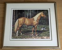 Front view of framed limited edition print showing palomino horse in forest clearing with triple matting and silver/gold toned wood frame