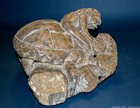 Front angle of stone carving showing the turtle with figure on its back