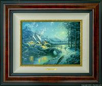 Full view of framed painting in burl studio frame with gold fillet and snowy landscape image.