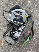 Mastercraft corded circular saw with silver casing and blue-tinted blade inside a black and red Jobmate toolbag on asphalt.