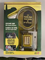 Front view of the boxed 24-inch flexible shaft LED grill light showing clamp-on and magnetic base and packaging details.