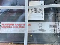 Close-up of shipping label and printed information on unopened packaging showing product details and origin.