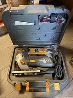 Top view of the Maximum corded jigsaw and DeWalt blades packaged inside the open black plastic carrying case.