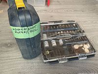 Closed plastic case labeled 'Mastercraft Rotary Tool' and accessory bits case.