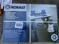 Photo of the unopened Kobalt 11 Amp Router with Router Table box showing product features and images.