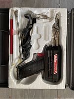 Weller Expert soldering gun and accessories in molded styrofoam inside plastic carrying case.