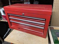 Photo of a red Waterloo tool chest with three drawers and lock on table