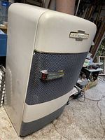 Front view of vintage Admiral refrigerator showing cream and textured blue two-tone metal exterior and chrome handle.