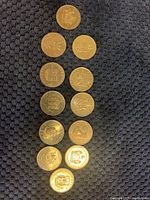 Full set of 11 provincial commemorative coins arranged in a vertical line showing front sides with provincial plaques.