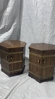 Full view of the pair of solid oak octagon shaped end tables with metal stud and handle details.