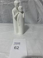 Photo of white Royal Doulton porcelain figurine depicting two brothers, one with hand on the other's shoulder.