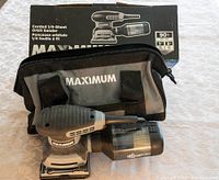 Maximum corded 1/4 sheet orbit sander with carry case and original box on a table.