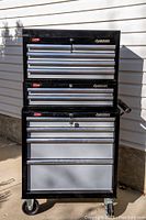 Front view of assembled three-piece Husky tool storage system showing 11 drawers and caster wheels