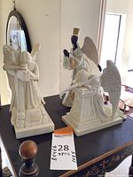 Three resin angel statues arranged on a table, showing positioning and scale.