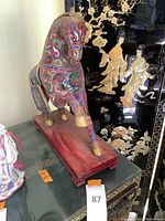 Three-quarter view showing overall shape, pose and cloisonné-style pattern