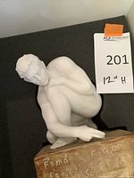 Close-up side view of matte white porcelain figure