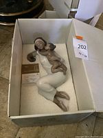Statue and certificate in original box showing overall lot contents