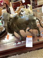 Front three-quarter view showing head, horns, and muscular detail